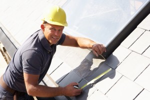 Roofer Working On Exterior Of New Home